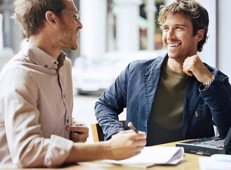 Two men talking over coffee