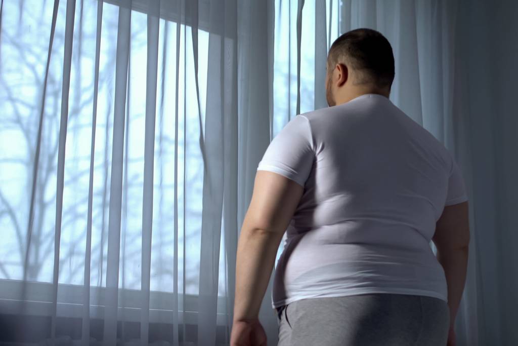 Fat Man Standing on the bed room
