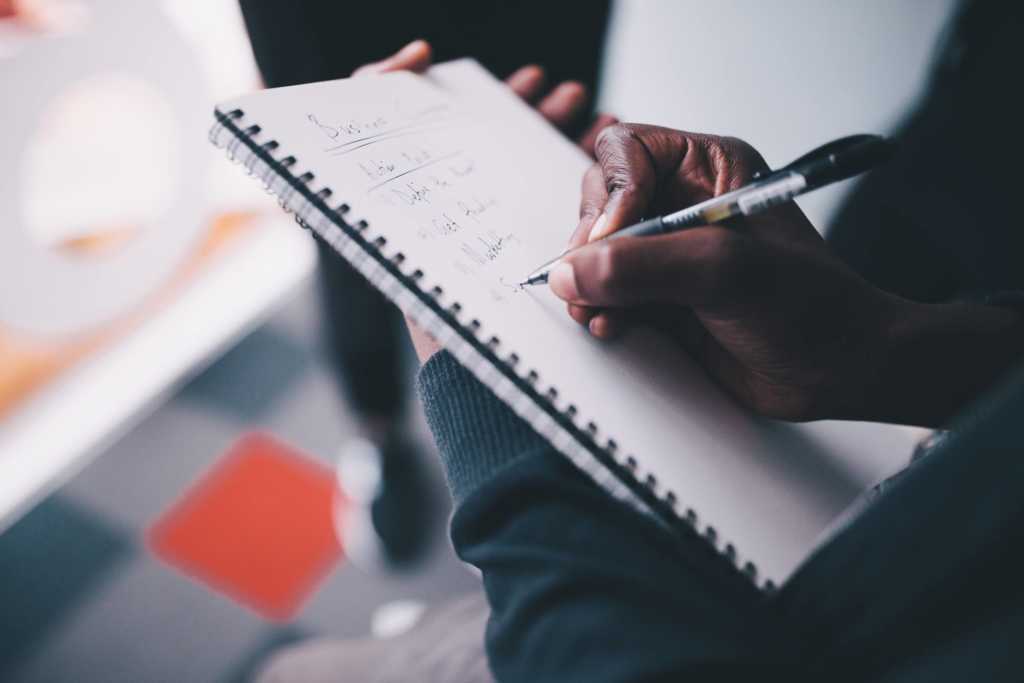 man writing to-do list 