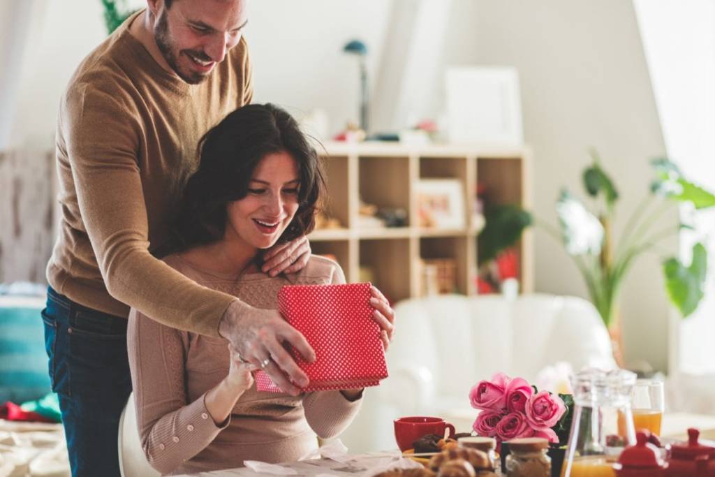 Man Giving Gift As Present To His wife 