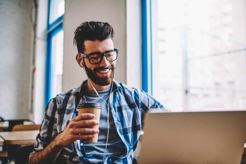 man smiling looking at the computer