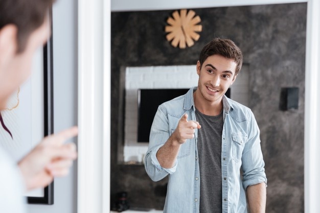 Young man posing infront of mirror