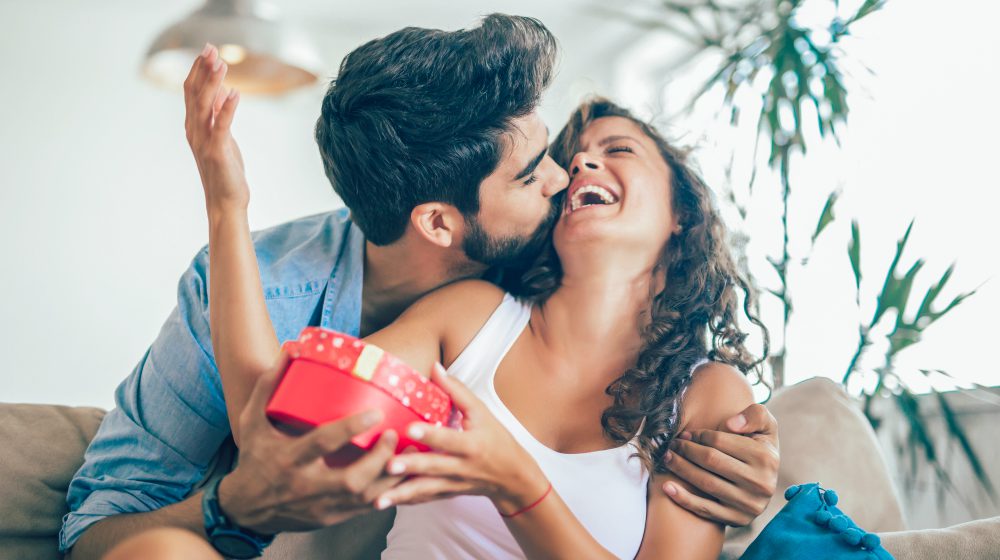 Man Giving Surprise Gift As Present To His Lovely Girlfriend 