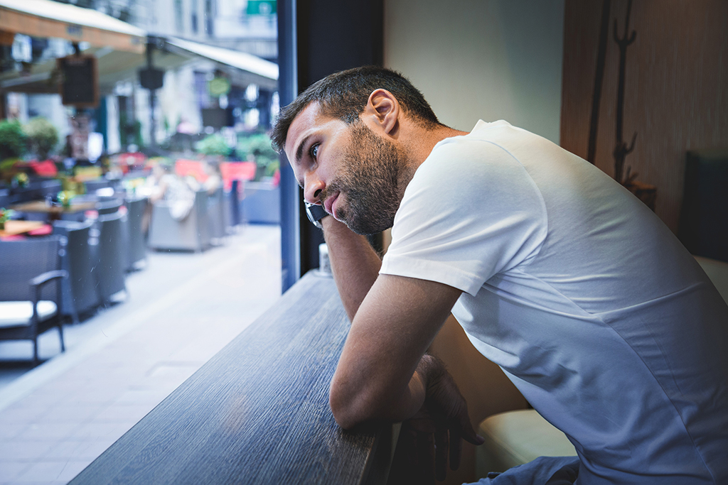 Young man looking out of window 