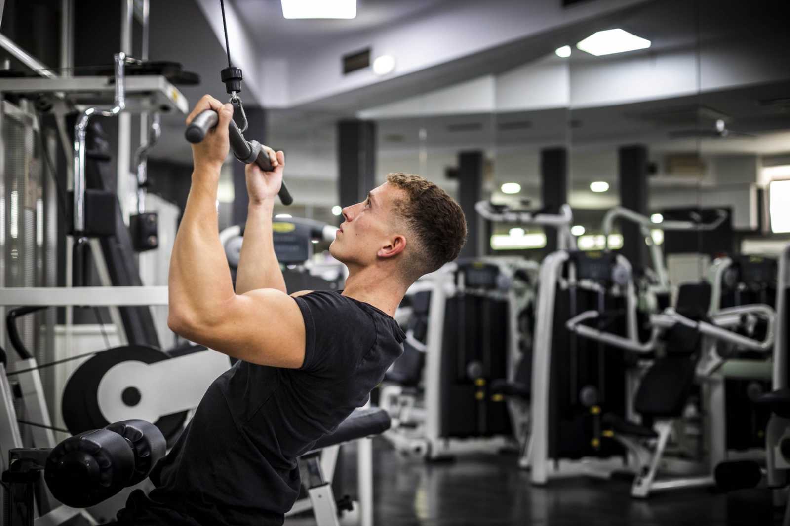 Man makes exercises at the gym