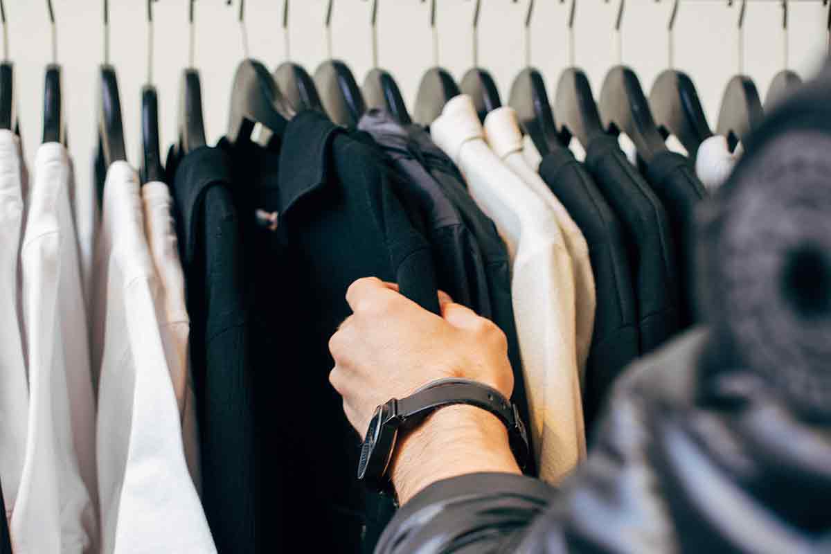 Handsome young man buying clothes in the store