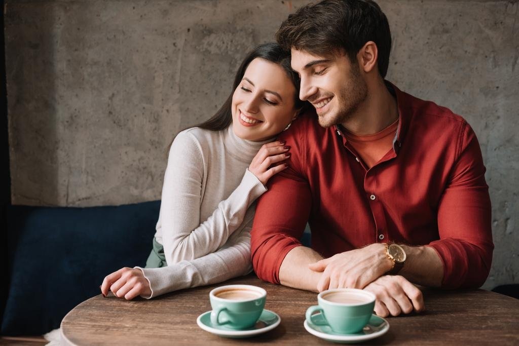 smiling-romantic-young-couple-hugging