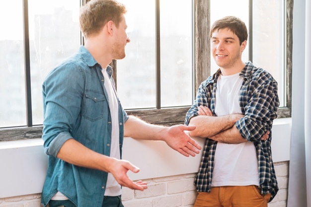 Two Focused Young Men Talking 
