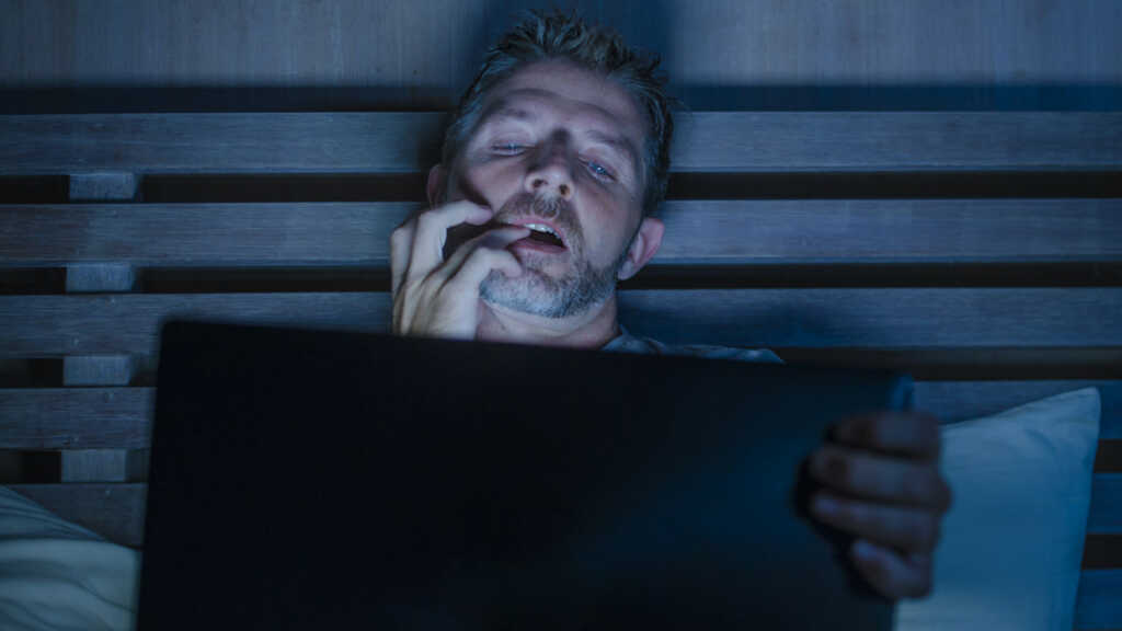 man watching at laptop