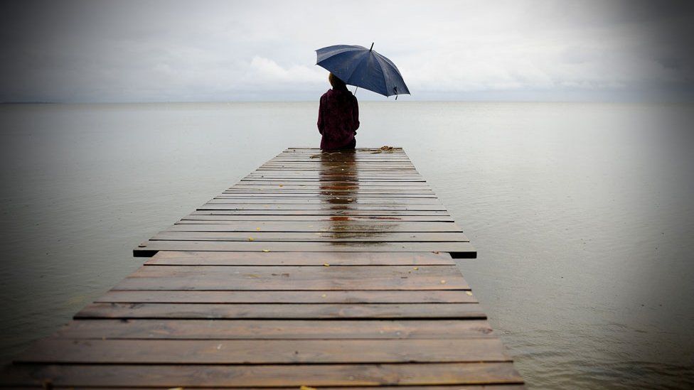 Alone - Single man sitting on the bridge all by himself