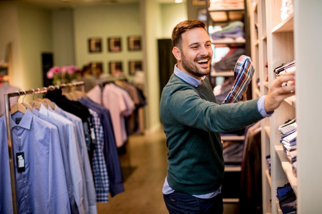 Handsome young man buying clothes in fashion store