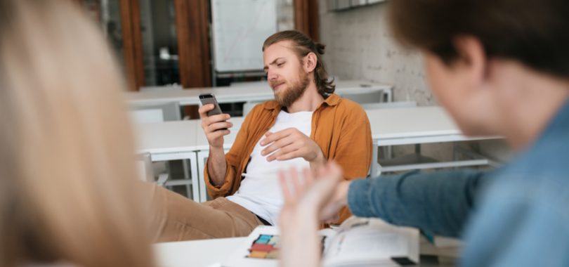 man using phone at office
