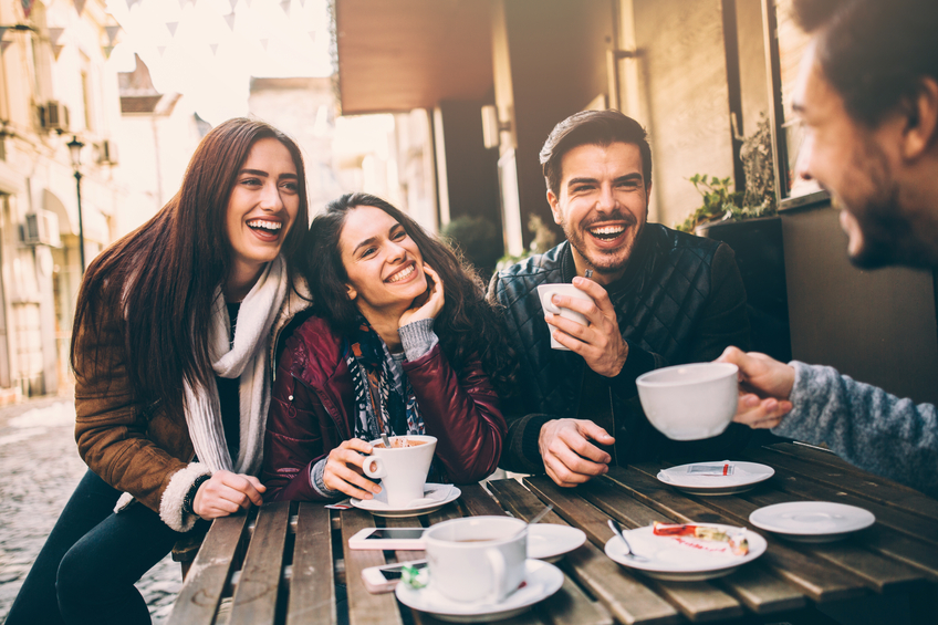 Happy young people having coffee and tea