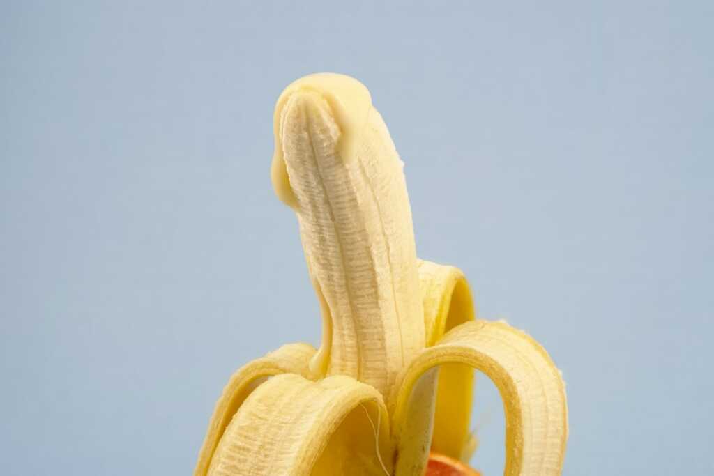 peeled banana with cream on top