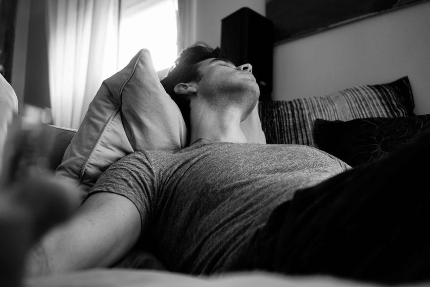 man sleeping on sofa