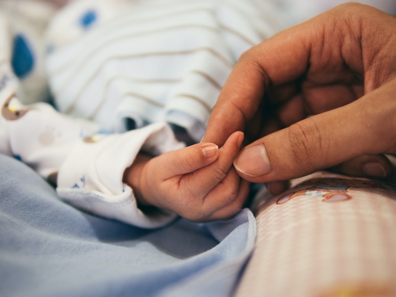 Holding a Baby's hands