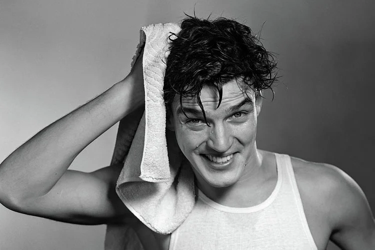 man dry his hair with towel