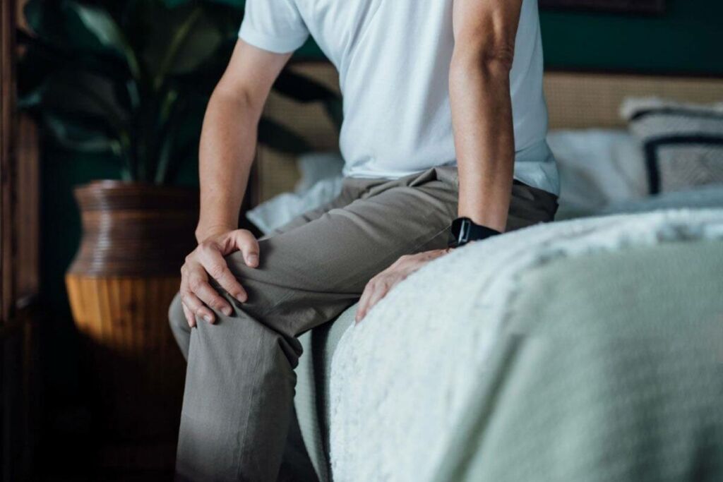 man sitting on bed