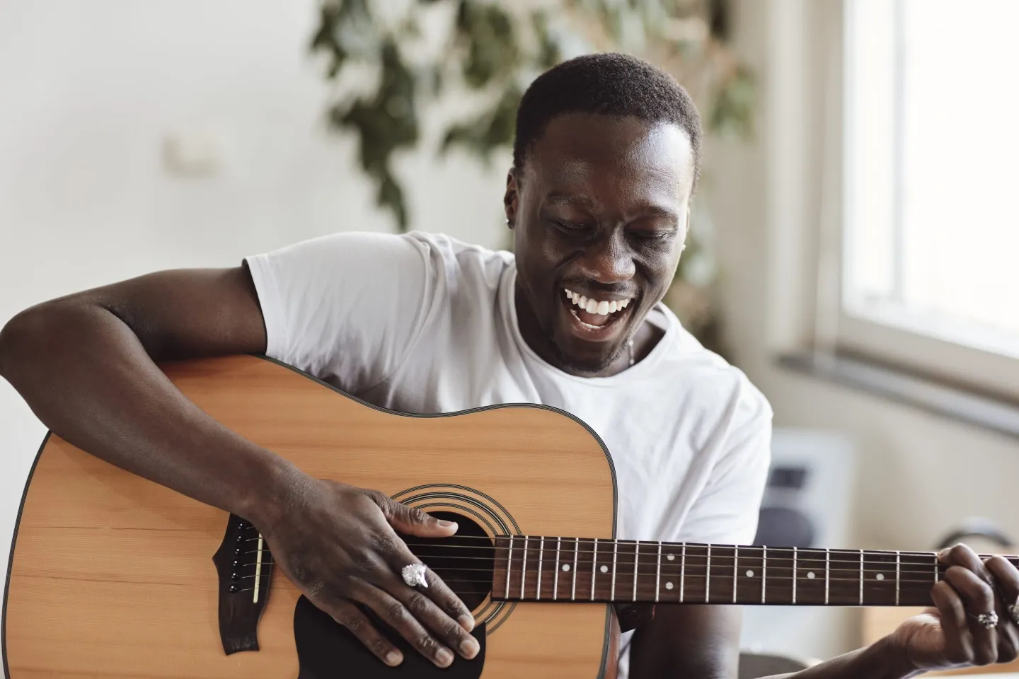 Happy man playing on the guitar
